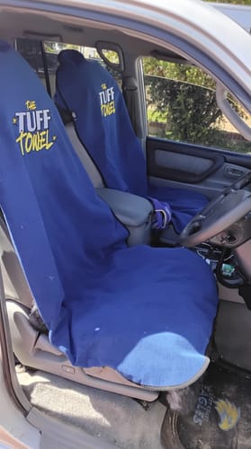 Customer's two blue Waterproof Car Towel Seat Covers draped over the driver and passenger seats of a car.