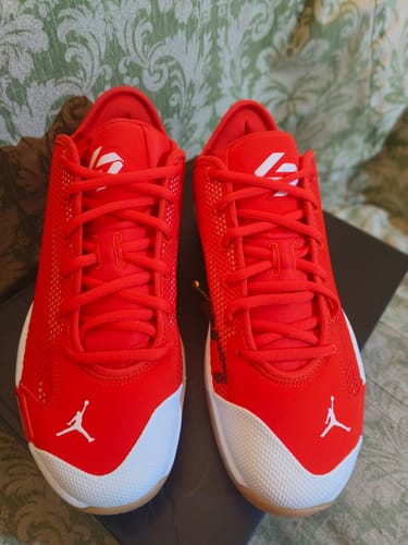 Customer's Nike Luka 77 'Chili Red' shoes from a top-down angle, showing the bright red uppers and white toe caps.