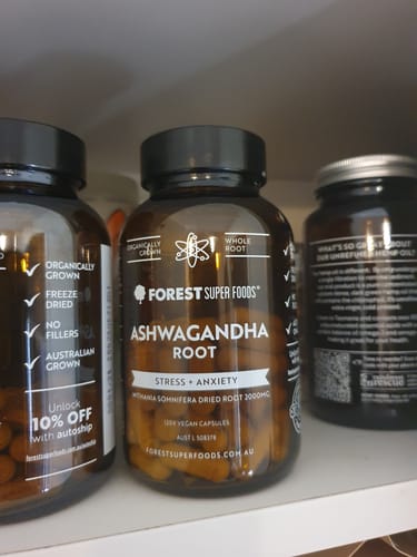 Customer's brown bottle of Organic Ashwagandha Capsules sitting on a white shelf.