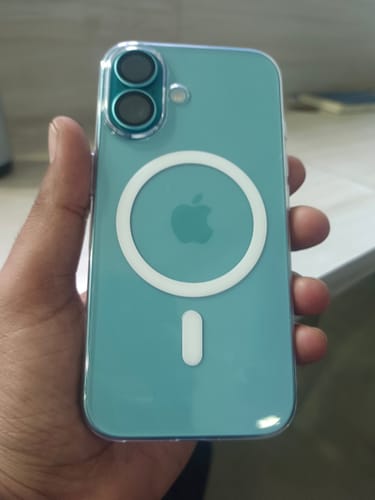 Customer holding a blue iPhone in the Anti Yellow Magsafe Clear Case, showing the white MagSafe ring and camera protection.