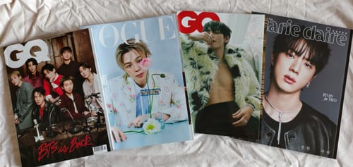 Customer's Marie Claire magazine with BTS Jin on the cover, displayed with other BTS-related magazines on a white surface.