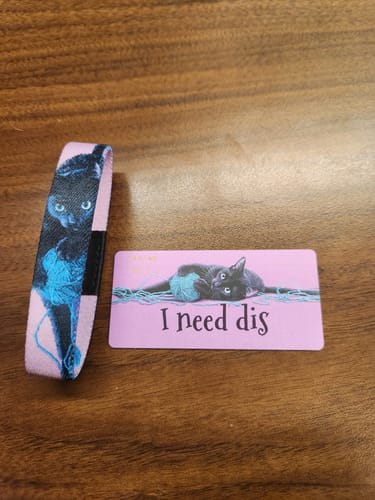 Customer's pink I Need Dis Cat Bracelet shown with its matching collector's card.