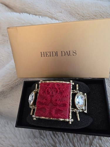 Customer's 'Lots of Luck Dragon' bracelet with a red design shown in its black presentation box.