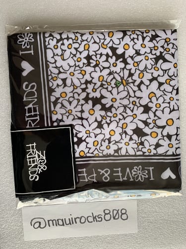Customer's ZOA Scarf with a cute daisy pattern, still in its original clear packaging.