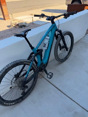 Customer's Snake Charmer Frame Keeper with a blue pattern installed on a teal mountain bike.