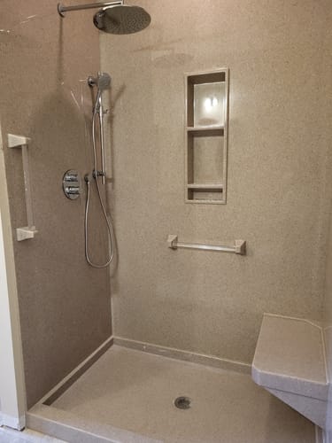 Customer's 2-Handle Shower System with an overhead rain head installed in a modern, beige shower.