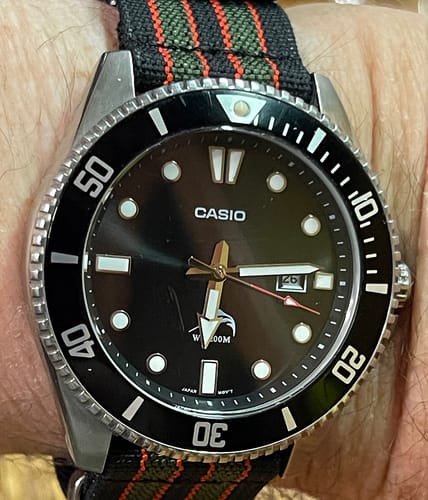 Customer's close-up view of the Ribbed Mako FN strap in Vintage Bond colors on a black dive watch.