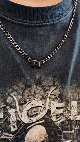 A customer wearing the stainless steel Legacy Necklace with two personalized beads.