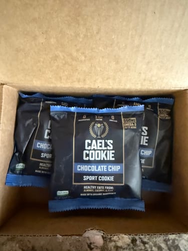 Customer's view of several wrapped Cael's Chocolate Chip Cookies in an open delivery box.