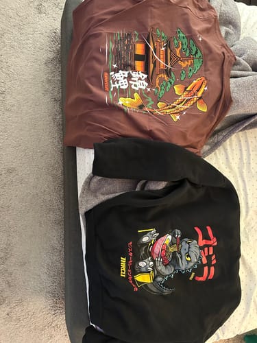 Customer's brownish-red YAMABUKI t-shirt laid flat, showing the colorful koi fish and pagoda graphic.