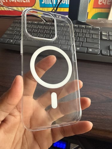Reviewer holding the transparent Magsafe Clear Case in their hand, showing the white MagSafe ring.