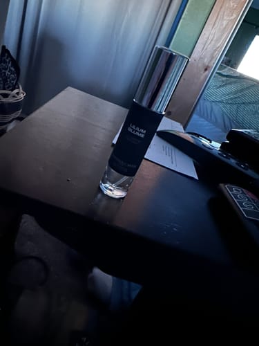 Customer's bottle of Lilium Blume Eau de Parfum standing on a dark table indoors.