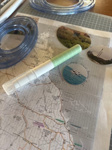 Customer's light green THINKing Glue Pen on a map for a crafting project.