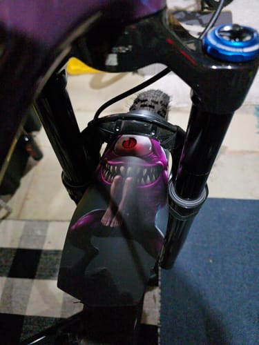 Customer's custom 'Purple People Eater' fender mounted between the front forks of a bike.