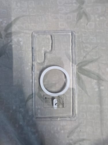Reviewer's clear Anti Yellow Magsafe Case for Samsung laid flat, showing the white magnetic ring on the back.