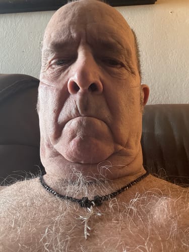 Close-up of a reviewer wearing the black beaded Legacy necklace against his chest.