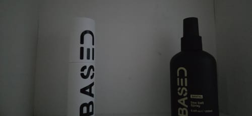 Reviewer's Based Texture Essentials products, showing a white container and a black sea salt spray bottle on a shelf.