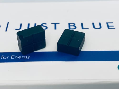 Customer's two square, dark blue Just Blue troches sitting on the product box.
