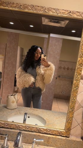 Customer takes a full-length mirror selfie showing the fit of the dark Seamless LowRise Leggings.