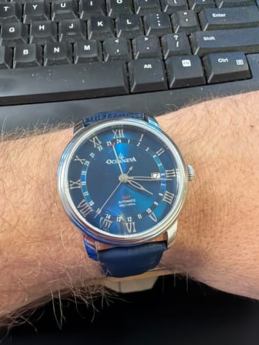 Customer showing the Oceaneva OceanTrek GMT watch with its blue dial and leather strap on their wrist.