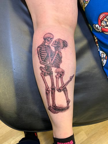Customer shows the finished skeleton tattoo on their leg, completed with The Painless All-Stars Kit.