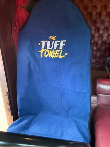 Customer's blue Tuff Towel seat cover shown fitted to a seat inside their truck.