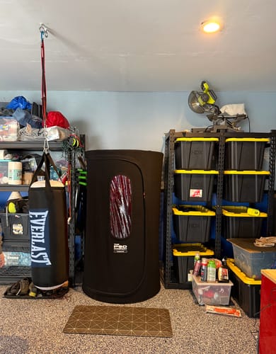 Customer's black Sauna Pod 2.0 set up in a home garage, ready for use.