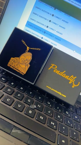 Customer's Custom Photo Engraved Pendant Necklace displayed in its black gift box on a laptop.