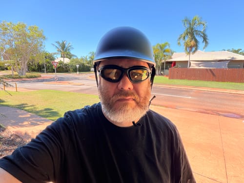 Reviewer wearing the Durable Polarized Riding Goggles with yellow lenses and a helmet outdoors.