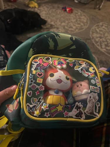 Reviewer's Rainforest Biome Backpack with cute figurines and stickers displayed in the transparent front pocket.