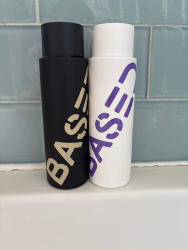Customer's Shower Duo, showing the black and white bottles side-by-side on a bathroom shelf.
