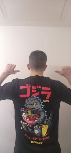 Reviewer showing the back of the black RAMEN MONSTER TEE, featuring a large graphic of a monster eating ramen.