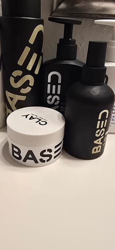 Customer's Texture & Hold Duo, featuring a white clay pot and black spray bottle, displayed with other hair products.