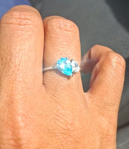 Customer wearing the Leesha Birthstone Ring, showing its two sparkly pear-cut stones.