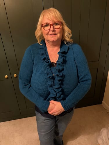 Reviewer wearing the finished teal Blue Hour Cardigan with a ruffled front.