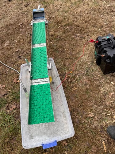 Customer's 6" Folding Sluice Box Extension with green mat, connected to a sluice setup outdoors.