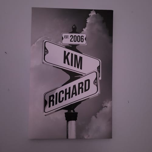 Reviewer's personalized canvas in a black-and-white street sign style, displaying the names 'Kim', 'Richard', and 'EST. 2006'.