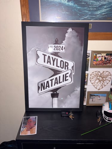 Customer's framed black-and-white print of two street signs with the names "Taylor" and "Natalie" and "EST. 2024" above them.