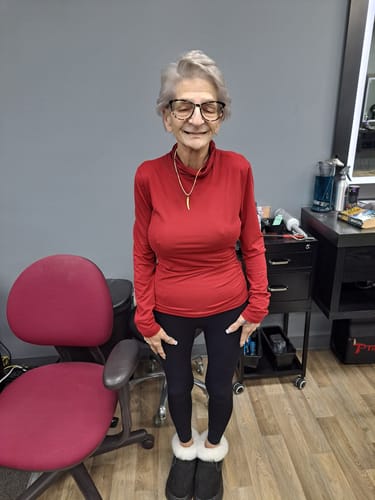 A customer stands wearing the black 3D Anti-Cellulite Leggings with her hands on her thighs.