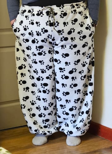 Customer wearing baggy pants made from the Black Paws on White Anti Pill Polar Fleece Fabric.