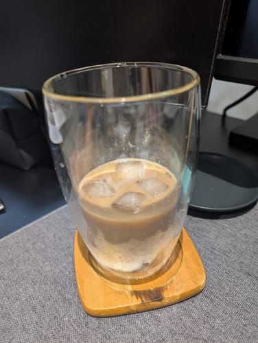 Customer's iced coffee made from Ethiopian Apex Trio beans, in a double-walled glass.