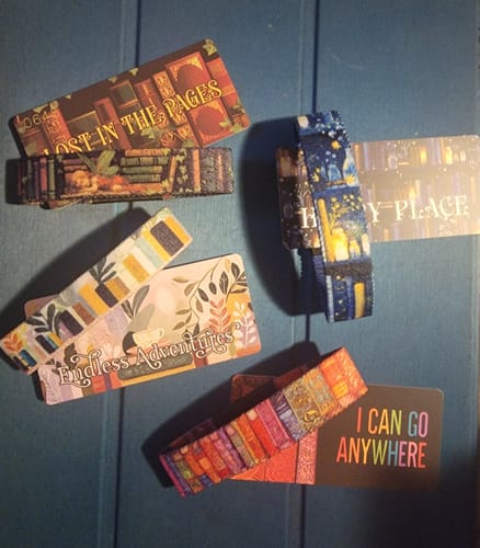 Customer displays their Happy Place Bracelet with three other colorful bracelets from a book-themed collection.