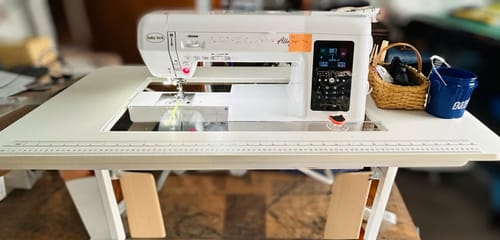 Customer's sewing machine in a white table, fitted with the custom insert to create a flush sewing surface.