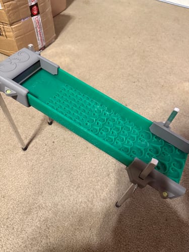 Customer's green Adventure Sluice with legs assembled, sitting on a carpeted floor indoors.