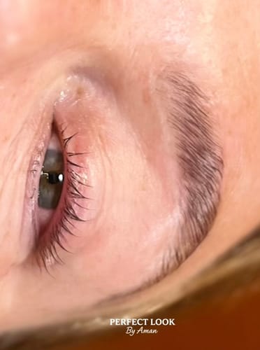 Close-up of a client's eye showing a neat lash lift achieved with Buff Lashes Glue Balm.