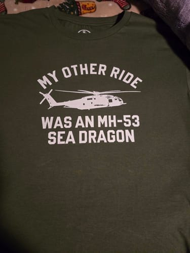 Customer's olive green t-shirt with the 'My Other Ride Was An MH-53 Sea Dragon' graphic laid flat.