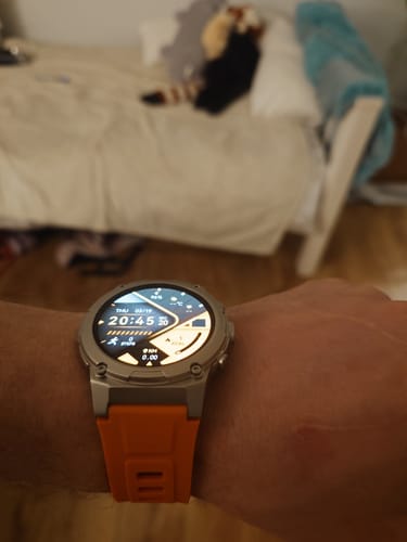 Customer's Gard Pro Ultra 3 watch featuring a silver case and a bright orange band, shown on their wrist indoors.