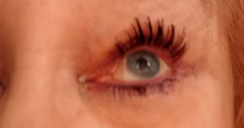 Close-up of a customer's eye showing long, separated lashes after applying three coats of My Amazing Lashes Mascara.