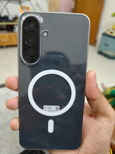 Customer holding a Samsung phone with the clear Anti Yellow Magsafe Case, showing the white magnetic ring on the back.