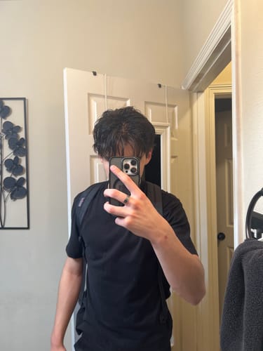 Reviewer showing their dark, textured hair after using the Sea Salt Spray.